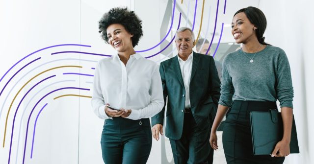Three diverse professionals walking together in modern office with purple and gold curved design elements on wall