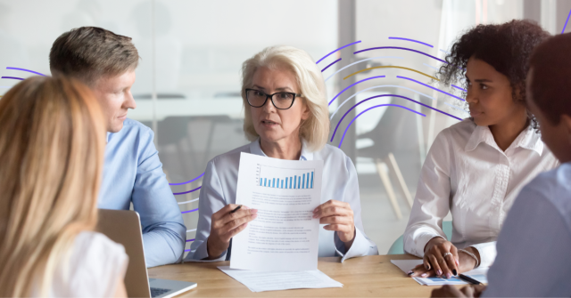 Business team reviewing financial report with bar chart during meeting in modern office setting